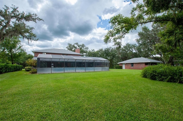 3990 NE Ashley Ter, Arcadia, FL 34266 - view of grassy yard featuring a lanai and an outdoor pool