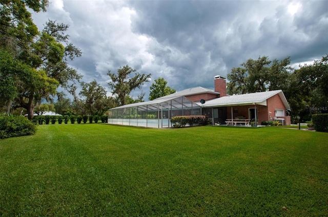 3990 NE Ashley Ter, Arcadia, FL 34266 - view of green lawn with a lanai