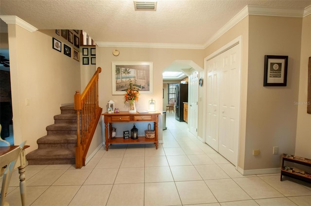 3990 NE Ashley Ter, Arcadia, FL 34266 - corridor with arched walkways, stairway, a textured ceiling, ornamental molding, and light tile patterned flooring