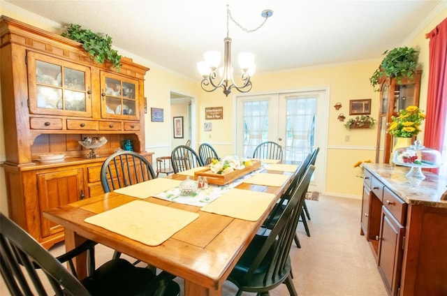 3990 NE Ashley Ter, Arcadia, FL 34266 - dining space featuring a chandelier, ornamental molding, light carpet, and french doors