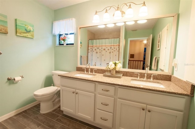 3990 NE Ashley Ter, Arcadia, FL 34266 - full bathroom featuring double vanity, wood finish floors, and curtained shower