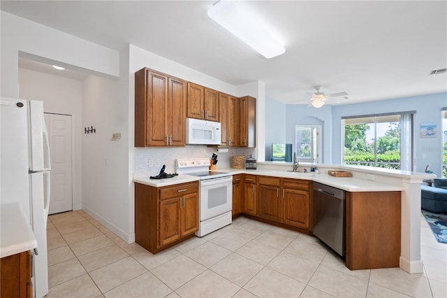 3820 Cobia Villas Ct, Punta Gorda, FL 33955 - kitchen featuring white appliances, a peninsula, light countertops, and brown cabinets