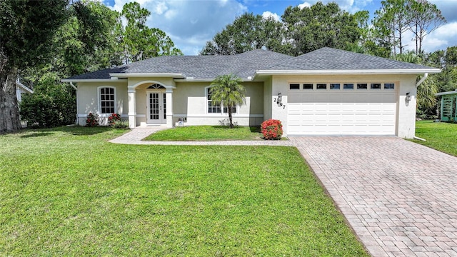 2697 Parrot St, North Port, FL 34286 - ranch-style house featuring stucco siding, decorative driveway, a garage, and a front lawn