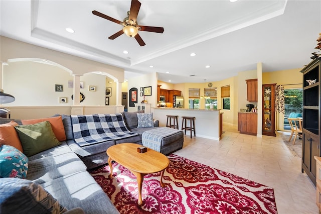 2697 Parrot St, North Port, FL 34286 - living area featuring a tray ceiling, ornate columns, recessed lighting, and plenty of natural light