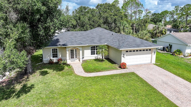 2697 Parrot St, North Port, FL 34286 - ranch-style house featuring stucco siding, an attached garage, driveway, and a front lawn