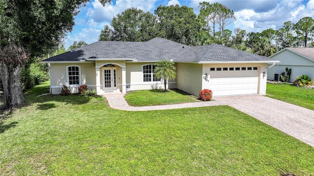 2697 Parrot St, North Port, FL 34286 - single story home with stucco siding, decorative driveway, a garage, and a front lawn