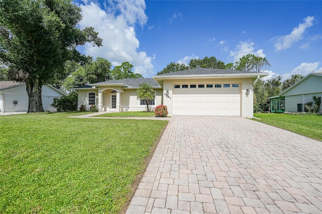 2697 Parrot St, North Port, FL 34286 - single story home with decorative driveway, stucco siding, a garage, and a front yard