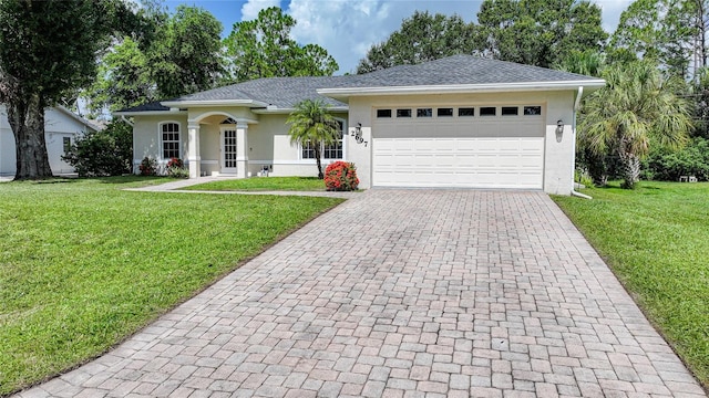 2697 Parrot St, North Port, FL 34286 - single story home featuring stucco siding, decorative driveway, a front lawn, and an attached garage