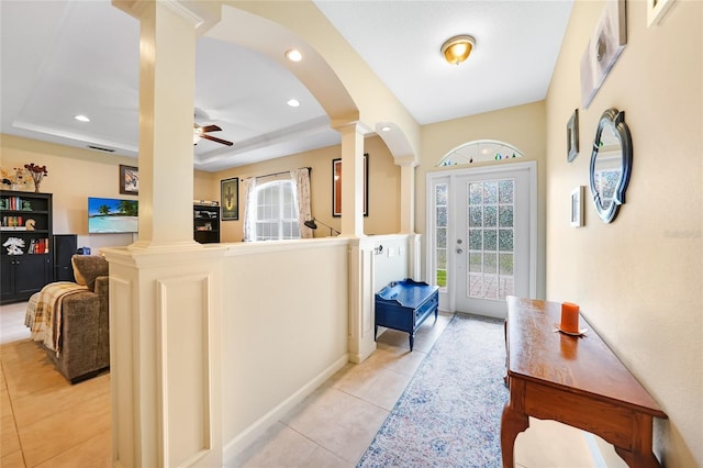 2697 Parrot St, North Port, FL 34286 - foyer with ornate columns, a raised ceiling, ceiling fan, light tile patterned floors, and recessed lighting