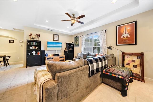 2697 Parrot St, North Port, FL 34286 - living room with a tray ceiling, ceiling fan, recessed lighting, and light tile patterned flooring