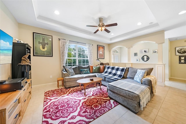 2697 Parrot St, North Port, FL 34286 - living area featuring a tray ceiling, recessed lighting, a ceiling fan, light tile patterned floors, and decorative columns