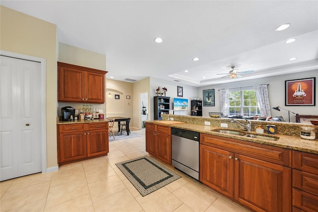 2697 Parrot St, North Port, FL 34286 - kitchen featuring stainless steel dishwasher, ceiling fan, light stone countertops, recessed lighting, and a tray ceiling