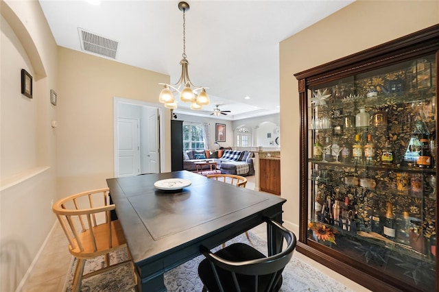 2697 Parrot St, North Port, FL 34286 - dining area featuring a ceiling fan, arched walkways, and a chandelier
