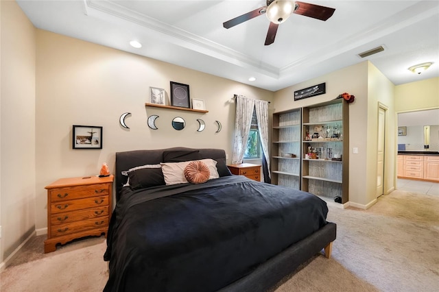 2697 Parrot St, North Port, FL 34286 - bedroom with a tray ceiling, light carpet, crown molding, recessed lighting, and ensuite bath