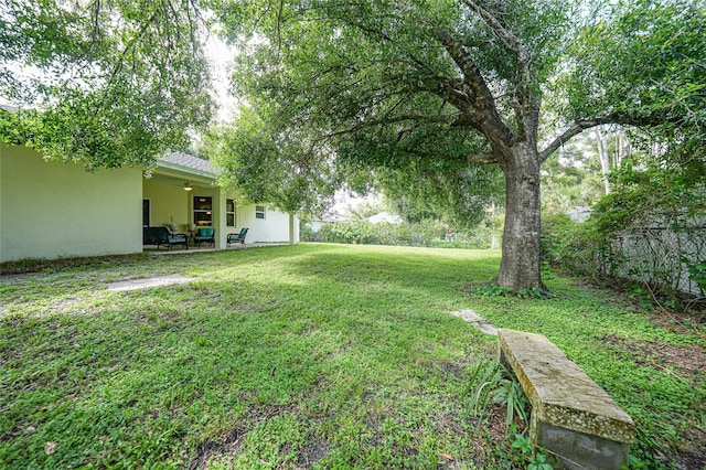 2697 Parrot St, North Port, FL 34286 - view of green lawn featuring a ceiling fan and a patio
