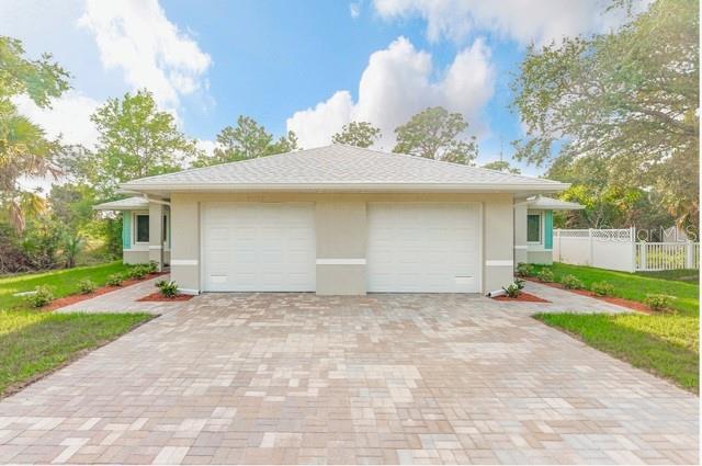 9471-9473 Agate St, Port Charlotte, FL 33981 - garage featuring decorative driveway