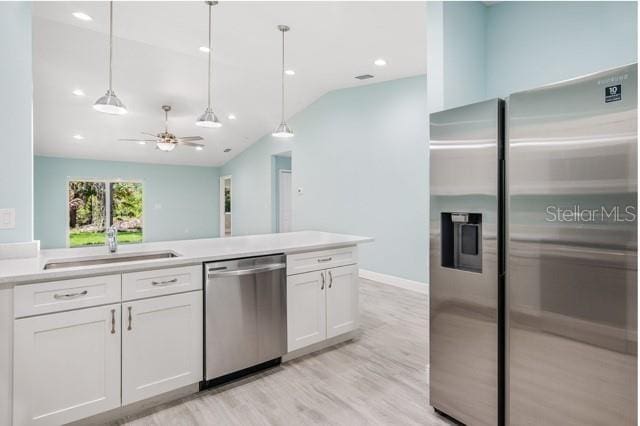 9471-9473 Agate St, Port Charlotte, FL 33981 - kitchen featuring appliances with stainless steel finishes, white cabinetry, lofted ceiling, light countertops, and hanging light fixtures