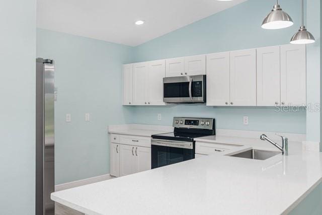 9471-9473 Agate St, Port Charlotte, FL 33981 - kitchen featuring stainless steel appliances, light countertops, a peninsula, decorative light fixtures, and recessed lighting
