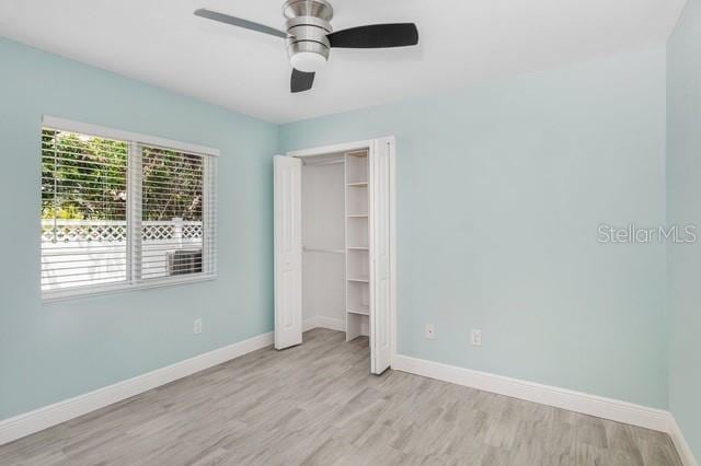 9471-9473 Agate St, Port Charlotte, FL 33981 - unfurnished bedroom with light wood-style floors, a ceiling fan, and a closet