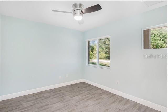 9471-9473 Agate St, Port Charlotte, FL 33981 - empty room featuring wood finished floors and ceiling fan