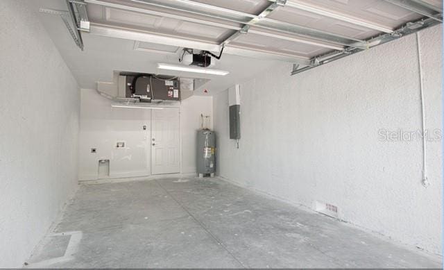 9471-9473 Agate St, Port Charlotte, FL 33981 - garage featuring water heater, electric panel, a textured wall, and a garage door opener