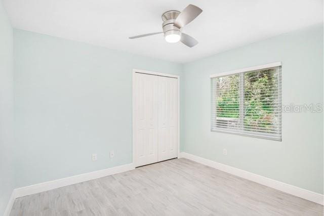 9471-9473 Agate St, Port Charlotte, FL 33981 - unfurnished bedroom with wood finished floors, a closet, and a ceiling fan