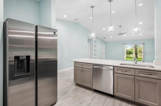9471-9473 Agate St, Port Charlotte, FL 33981 - kitchen featuring stainless steel appliances, gray cabinetry, lofted ceiling, light countertops, and light wood-type flooring