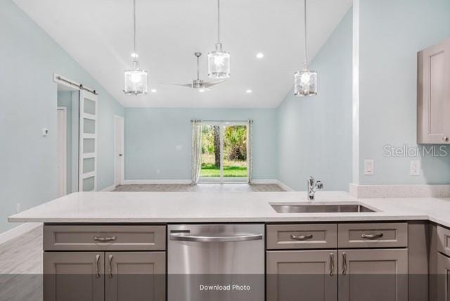 9471-9473 Agate St, Port Charlotte, FL 33981 - kitchen with stainless steel dishwasher, gray cabinets, a peninsula, and lofted ceiling