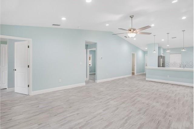 9471-9473 Agate St, Port Charlotte, FL 33981 - unfurnished living room featuring light wood finished floors, vaulted ceiling, a ceiling fan, and recessed lighting