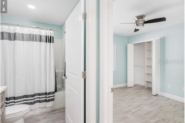 9471-9473 Agate St, Port Charlotte, FL 33981 - full bath with vanity, wood finished floors, shower / tub combo with curtain, and a ceiling fan