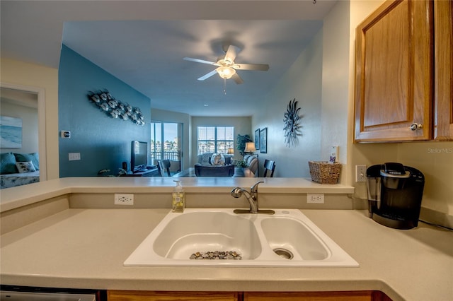 2090 Matecumbe Key Rd Unit 1202, Punta Gorda, FL 33955 - kitchen featuring open floor plan, ceiling fan, light countertops, dishwashing machine, and brown cabinetry
