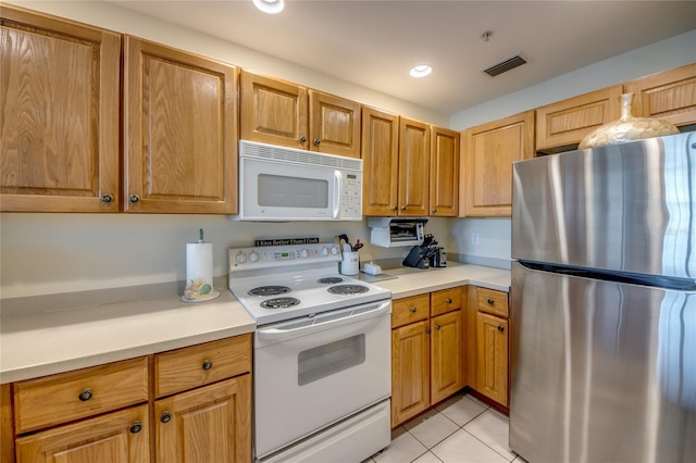 2090 Matecumbe Key Rd Unit 1202, Punta Gorda, FL 33955 - kitchen featuring white appliances, light countertops, light tile patterned floors, and recessed lighting