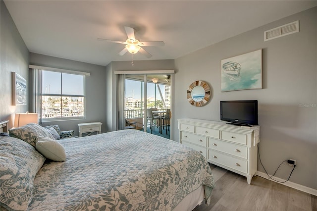 2090 Matecumbe Key Rd Unit 1202, Punta Gorda, FL 33955 - bedroom featuring access to exterior, light wood-style flooring, and ceiling fan