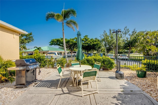 2090 Matecumbe Key Rd Unit 1202, Punta Gorda, FL 33955 - view of patio featuring a grill and outdoor dining space