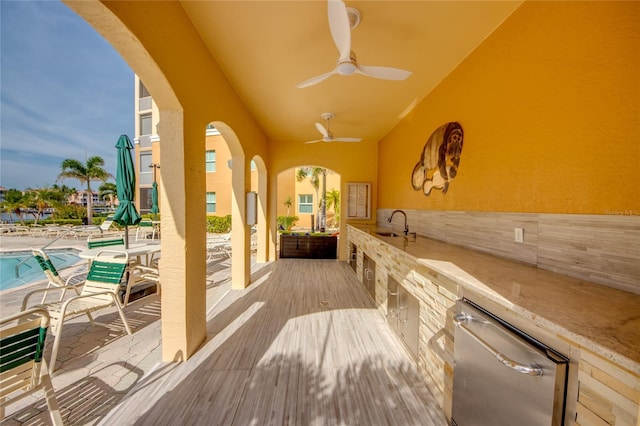 2090 Matecumbe Key Rd Unit 1202, Punta Gorda, FL 33955 - wooden terrace with ceiling fan, a community pool, and a patio area