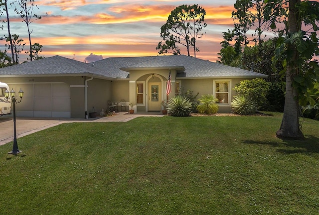 1445 Gauguin Rd, North Port, FL 34288 - ranch-style house featuring an attached garage, stucco siding, a lawn, and driveway