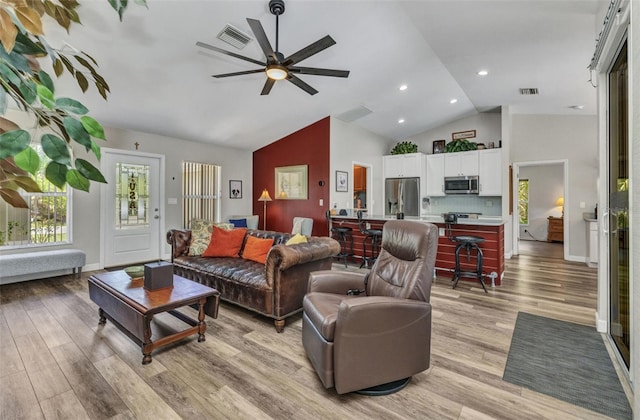 1445 Gauguin Rd, North Port, FL 34288 - living room featuring healthy amount of natural light, light wood-style flooring, a ceiling fan, high vaulted ceiling, and recessed lighting