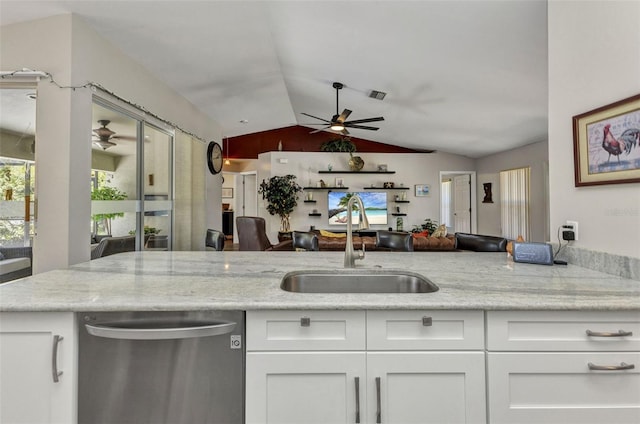 1445 Gauguin Rd, North Port, FL 34288 - kitchen featuring dishwasher, ceiling fan, lofted ceiling, white cabinetry, and light stone counters