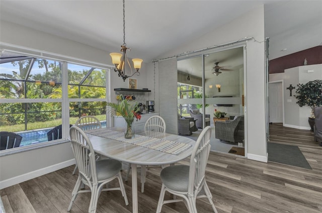 1445 Gauguin Rd, North Port, FL 34288 - dining area featuring ceiling fan, wood finished floors, vaulted ceiling, a chandelier, and a sunroom