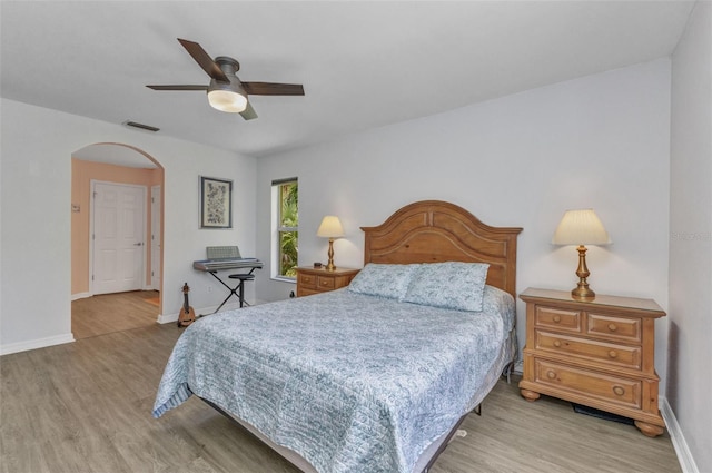 1445 Gauguin Rd, North Port, FL 34288 - bedroom featuring light wood-style flooring, arched walkways, and ceiling fan