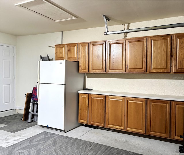 1445 Gauguin Rd, North Port, FL 34288 - kitchen with freestanding refrigerator and brown cabinetry