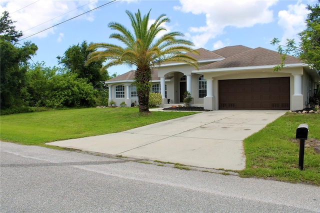 8039 Agate St, Port Charlotte, FL 33981 - view of front of house with a front yard, an attached garage, stucco siding, and concrete driveway