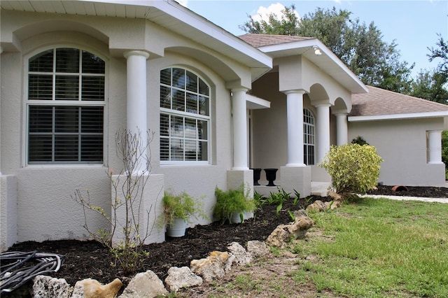 8039 Agate St, Port Charlotte, FL 33981 - view of side of home featuring stucco siding and roof with shingles