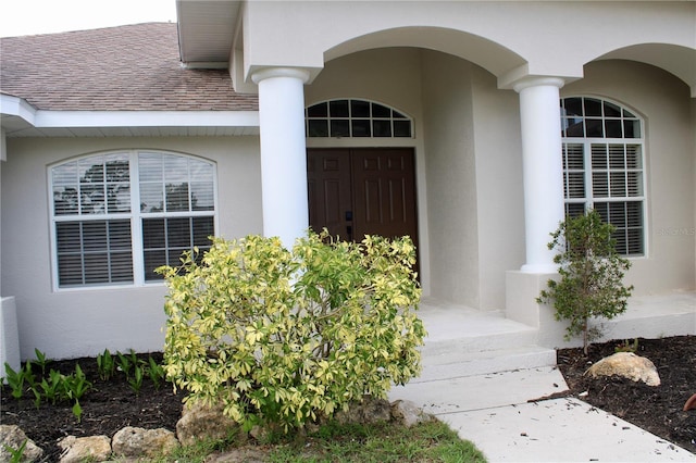 8039 Agate St, Port Charlotte, FL 33981 - property entrance featuring roof with shingles and stucco siding