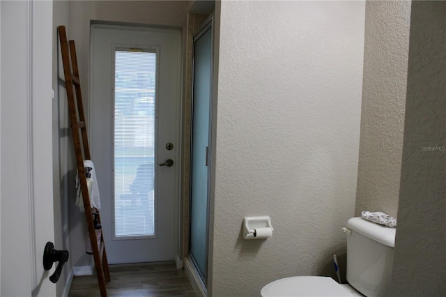 8039 Agate St, Port Charlotte, FL 33981 - bathroom with wood finished floors, a textured wall, and a shower with door