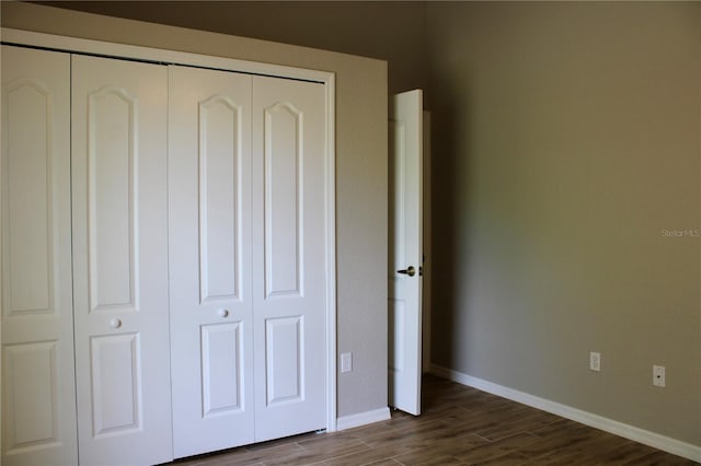 8039 Agate St, Port Charlotte, FL 33981 - unfurnished bedroom with dark wood-type flooring and a closet