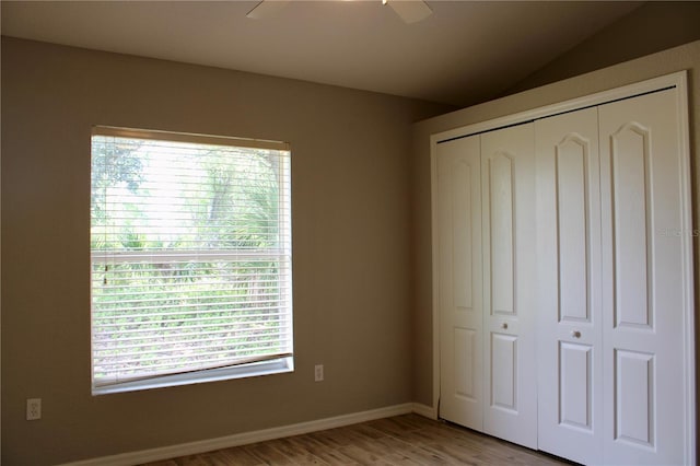 8039 Agate St, Port Charlotte, FL 33981 - unfurnished bedroom with a closet, light wood-style flooring, ceiling fan, and vaulted ceiling