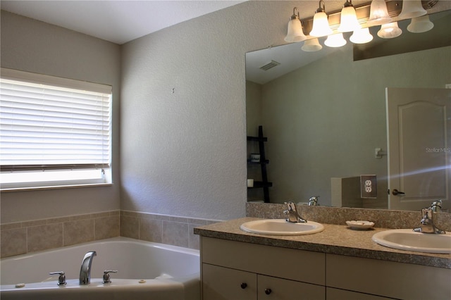 8039 Agate St, Port Charlotte, FL 33981 - full bath with double vanity, a garden tub, and a textured wall