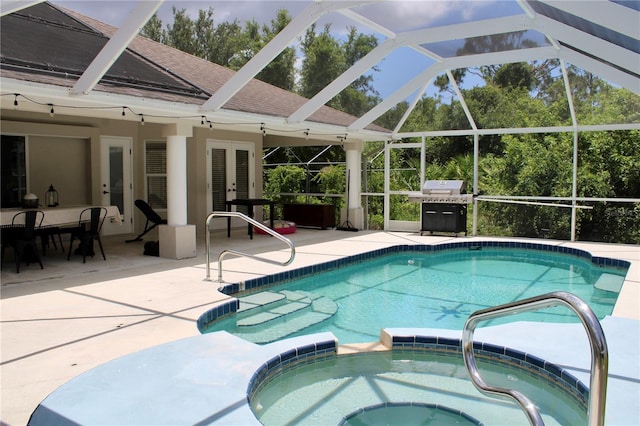 8039 Agate St, Port Charlotte, FL 33981 - view of pool featuring french doors, a patio, a pool with connected hot tub, a lanai, and a grill