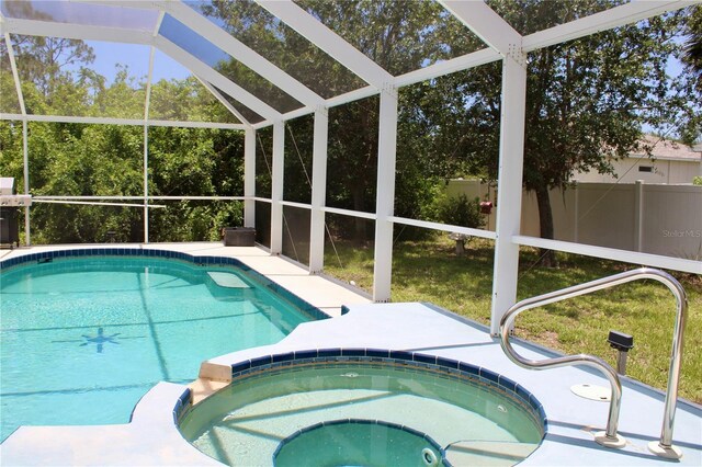 8039 Agate St, Port Charlotte, FL 33981 - view of pool featuring a pool with connected hot tub, glass enclosure, and a patio area